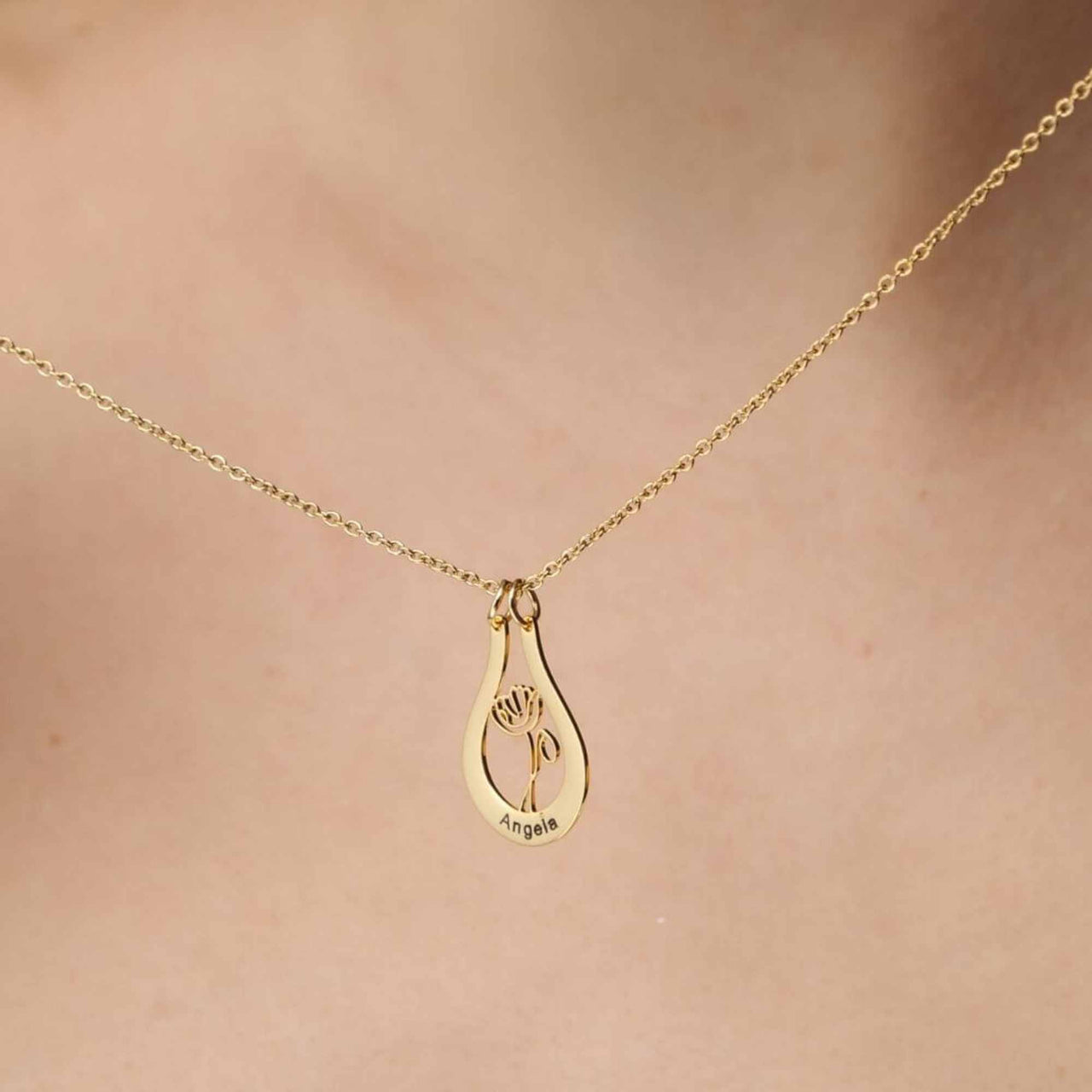 Birth Flower Name Necklace by Brother & Sisters featuring a gold pendant with flower design and custom name.