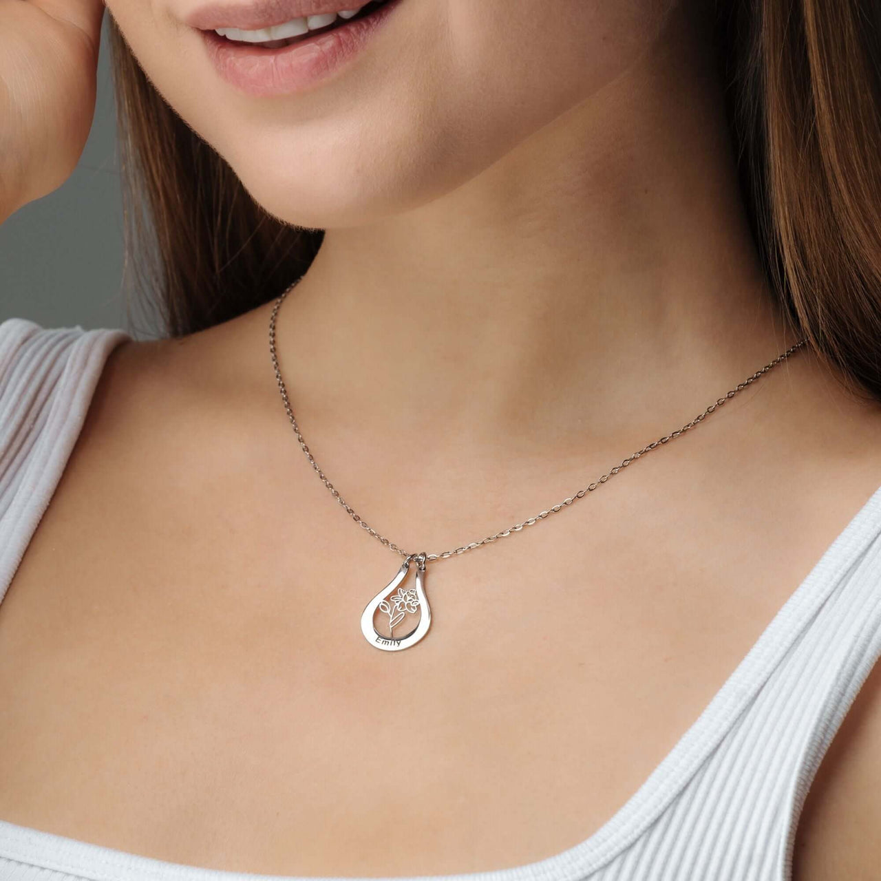 Birth Flower Name Necklace worn by a woman, showcasing its elegant design and personalized charm by Brother & Sisters.