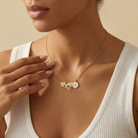 Thumbnail for Daisy Name Necklace by Brother & Sisters featuring three hearts and a white enamel daisy, worn elegantly.