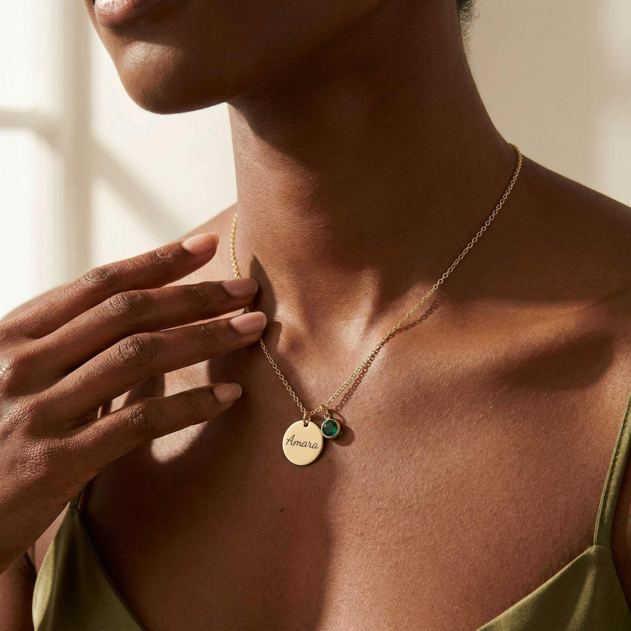 Precious Name Necklace by Brother & Sisters features gold pendant with engraved name and a birthstone crystal.
