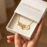 Thumbnail for Daisy Name Necklace by Brother & Sisters displayed in a gift box, featuring engraved hearts and a delicate enamel daisy.