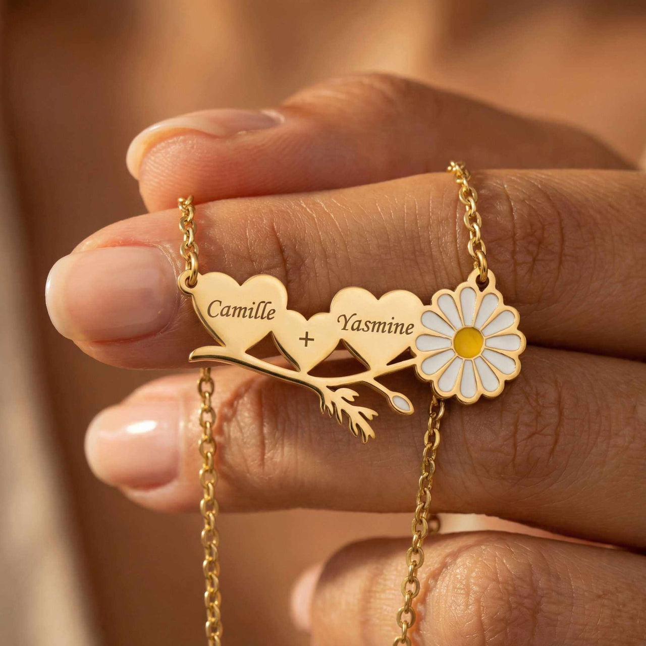 Daisy Name Necklace featuring engraved hearts and a white enamel daisy by Brother & Sisters.
