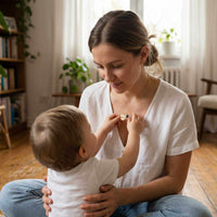Thumbnail for Precious Name Necklace worn by a mother, with a child admiring the engraved pendant, by Brother & Sisters.