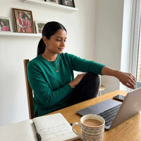 Thumbnail for Woman wearing a Photo Projection Bracelet, seated at a desk with a laptop and coffee, showcasing comfort and style from Brother & Sisters.