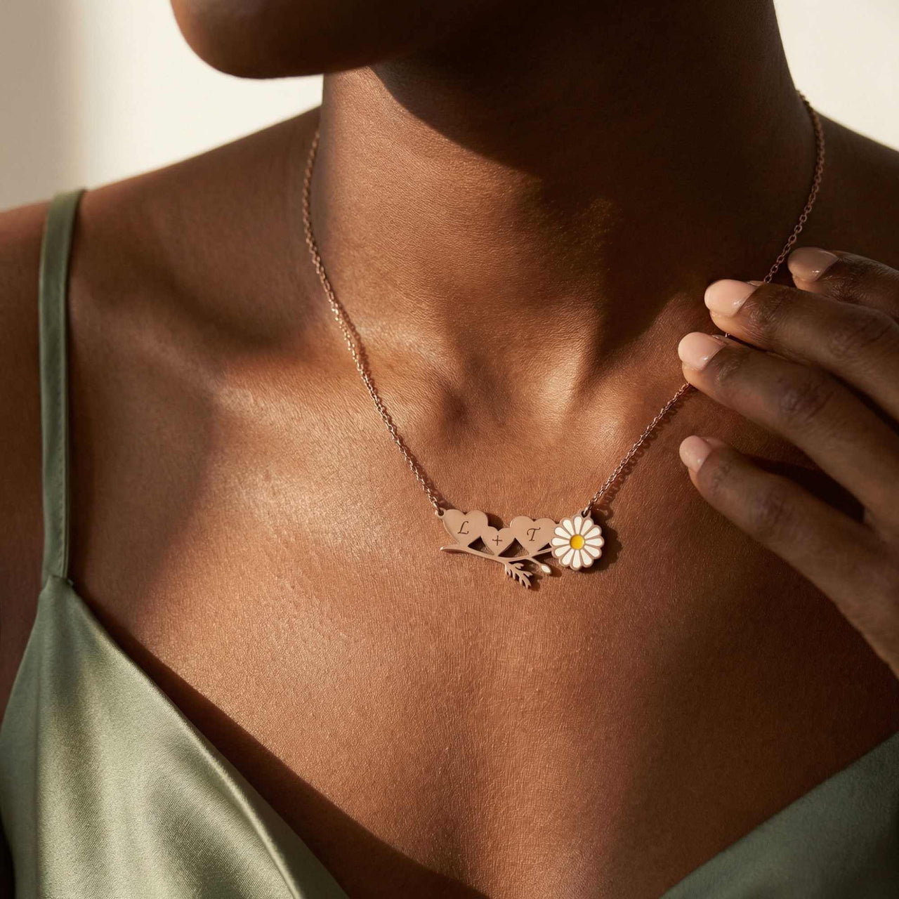 Daisy Name Necklace featuring engraved names and a white enamel daisy by Brother & Sisters, showcasing personal jewelry.