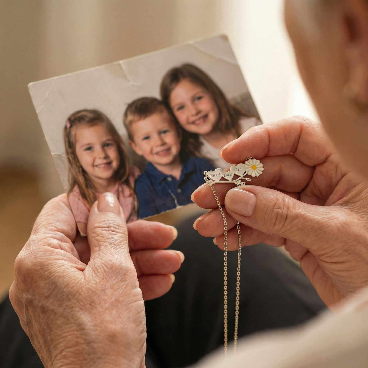 A woman holding a Daisy Name Necklace while looking at a photo of her children, showcasing love and personalization.