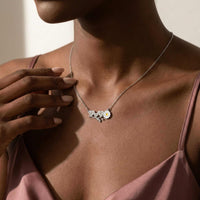 Thumbnail for Daisy Name Necklace showcasing three engraved hearts and a white enamel daisy by Brother & Sisters.