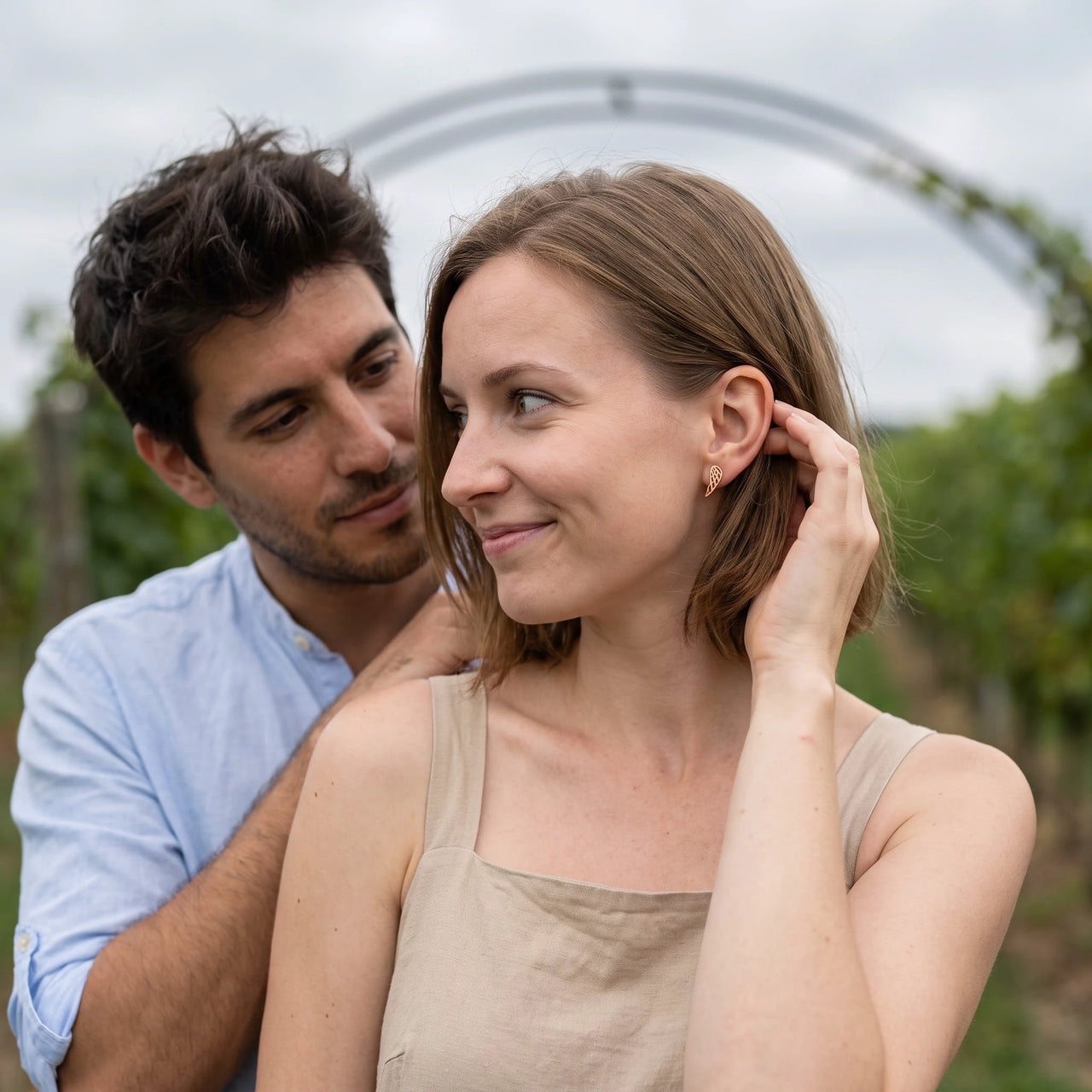 Woman gently touching her gold stud earrings | SKU: 42008-gold