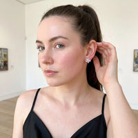 Thumbnail for Woman gently touching her Austrian Crystals Flowers Earrings in silver | SKU: 419620-silver