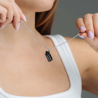 Thumbnail for Baby Bottle Name Necklace held by a woman, showcasing personalized jewelry from Brother & Sisters.