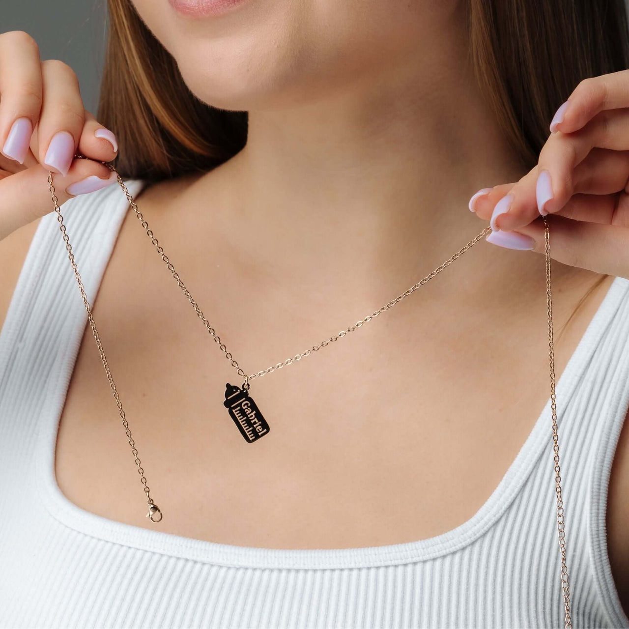 Woman wearing Baby Bottle Name Necklace with a personalized bottle-shaped pendant.