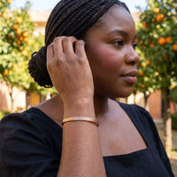 Thumbnail for Woman gently touching her Be The Unique Version Of Yourself bracelet in rose gold | SKU: btuvoy-rg