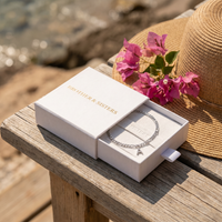 Thumbnail for Pavé Initial Anklet silver in Brother & Sisters gift box on beach