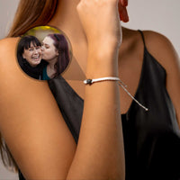 Thumbnail for White Photo Bracelet featuring a personalized photo pendant from Brother & Sisters worn on a woman's wrist.