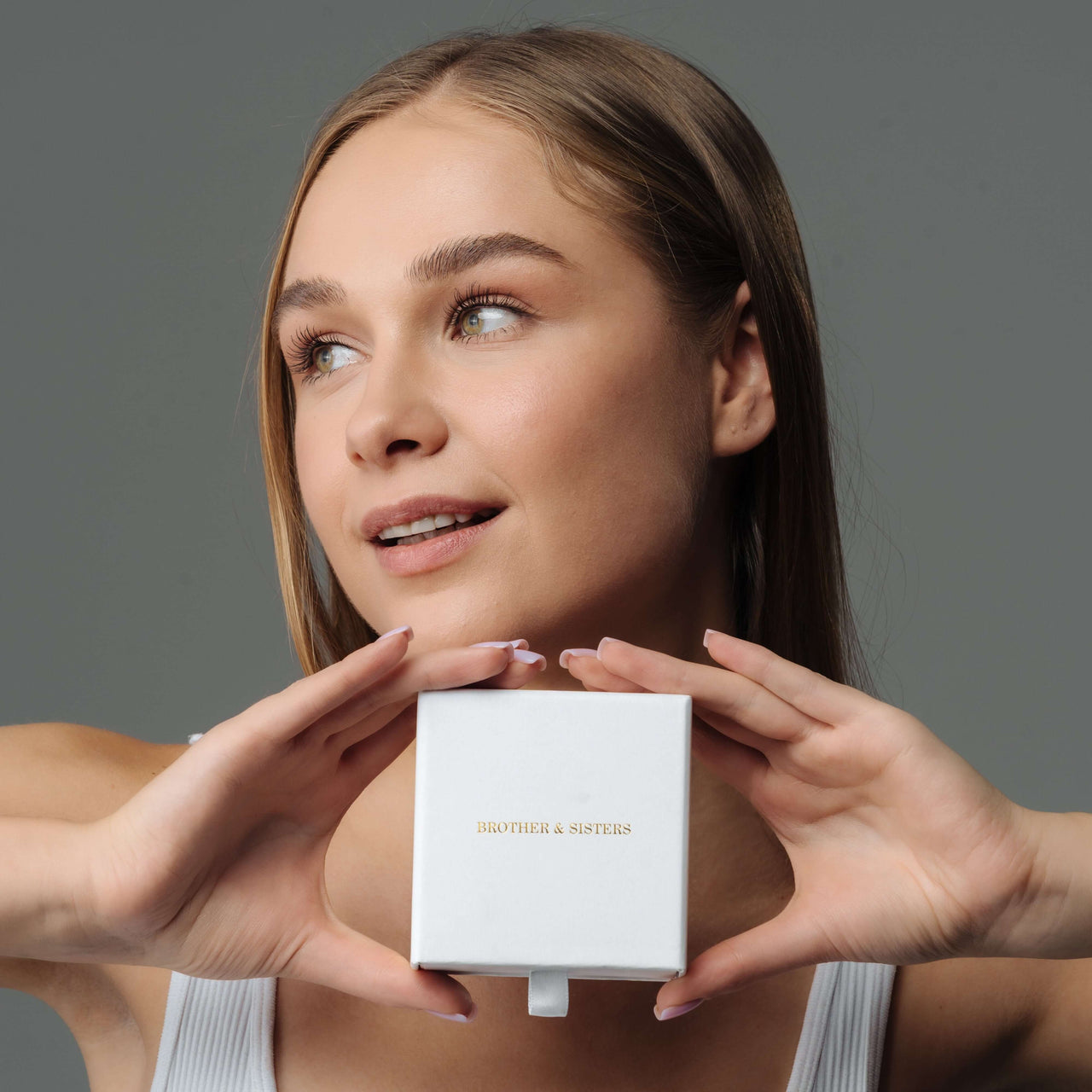 Model holding a Brother & Sisters gift box, showcasing the Birth Flower Name Necklace.