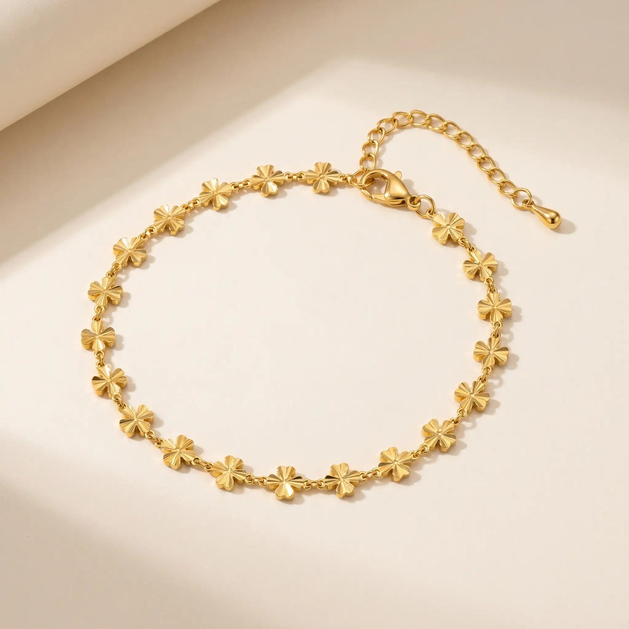 Daisy Charm Anklet featuring 18K gold plated stainless steel with continuous chain of four-petal flowers by Brother & Sisters.
