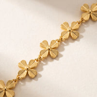 Thumbnail for Daisy Charm Anklet featuring 18K gold plated stainless steel and continuous chain of small 4-petal daisies by Brother & Sisters.