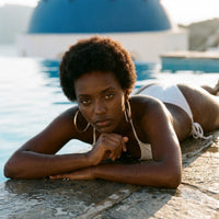 Thumbnail for Diamond Cut Statement Hoops in Gold, worn by a pool in Santorini | SKU: 41009-gold