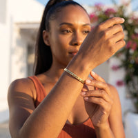 Thumbnail for Woman gently touching her gold engraved cuff bracelet | SKU: 4214557-gold-color