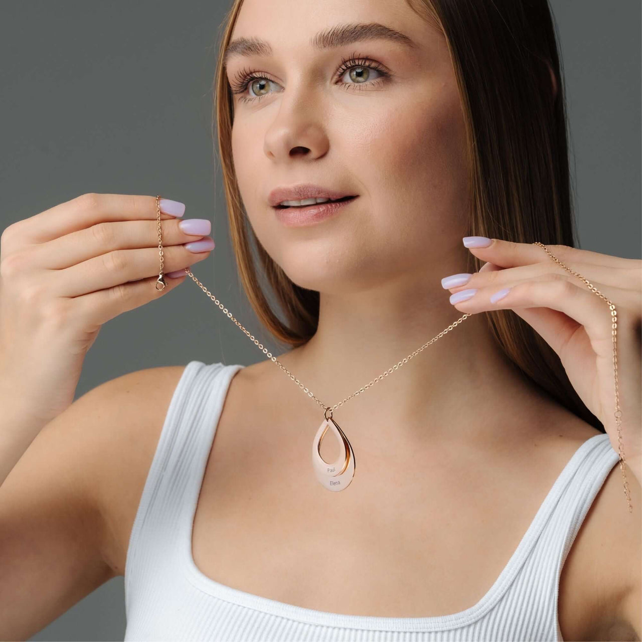 Model showcasing the elegant Drop Name Necklace by Brother & Sisters, featuring a personalized drop-shaped design.