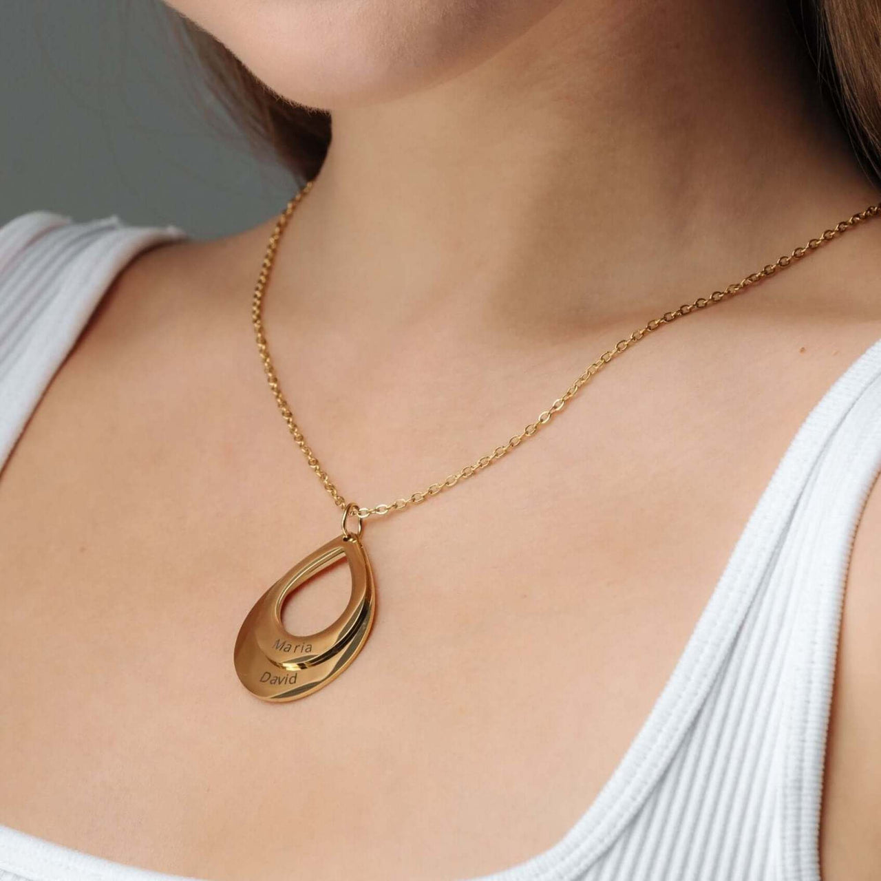 Drop Name Necklace by Brother & Sisters featuring a gold drop-shaped design with personalized names.