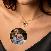 Thumbnail for Eternal Photo Necklace by Brother & Sisters featuring a heart charm with a photo projection of two smiling girls.