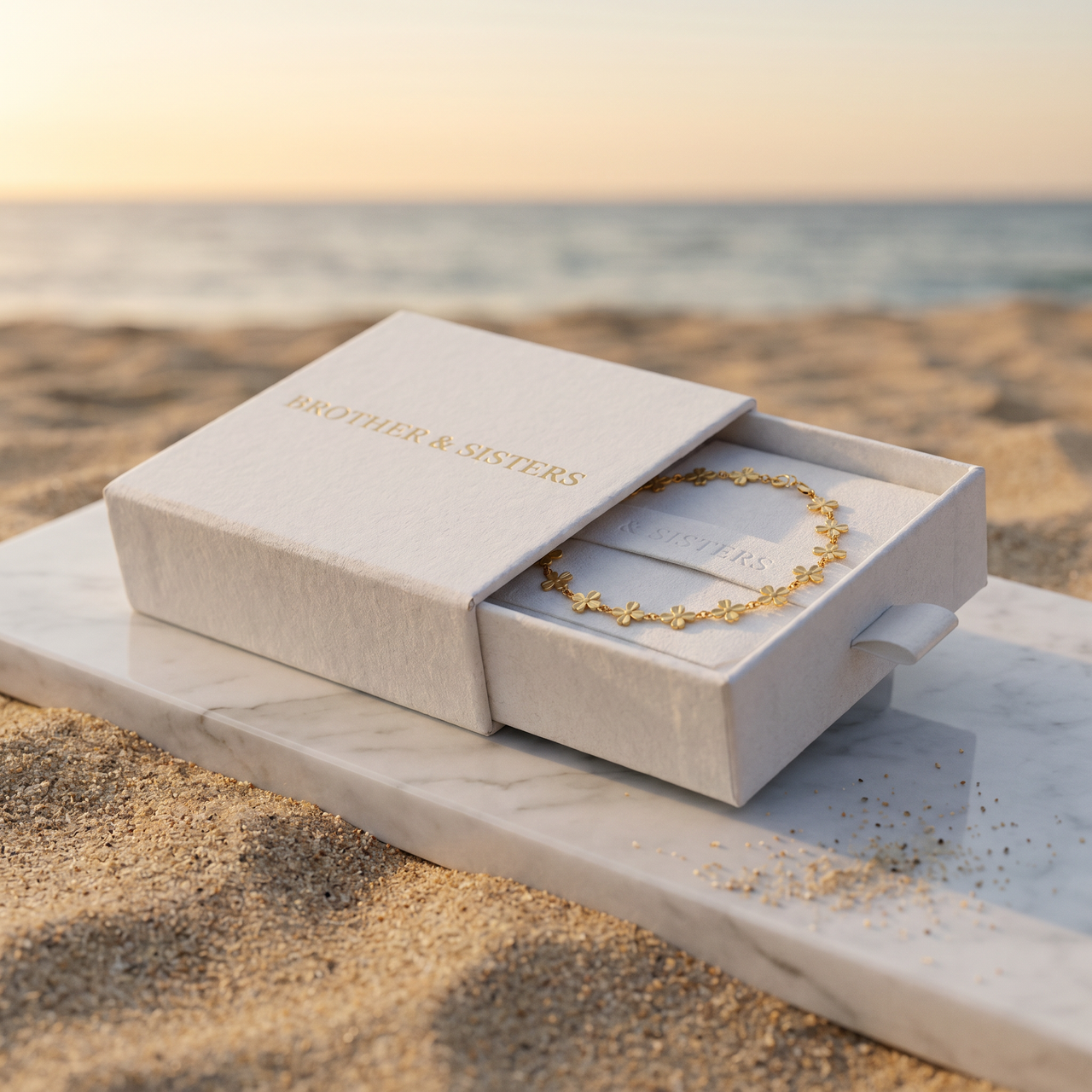 Daisy Charm Anklet in a Brother & Sisters box, a beautiful gold piece representing summer vibes.
