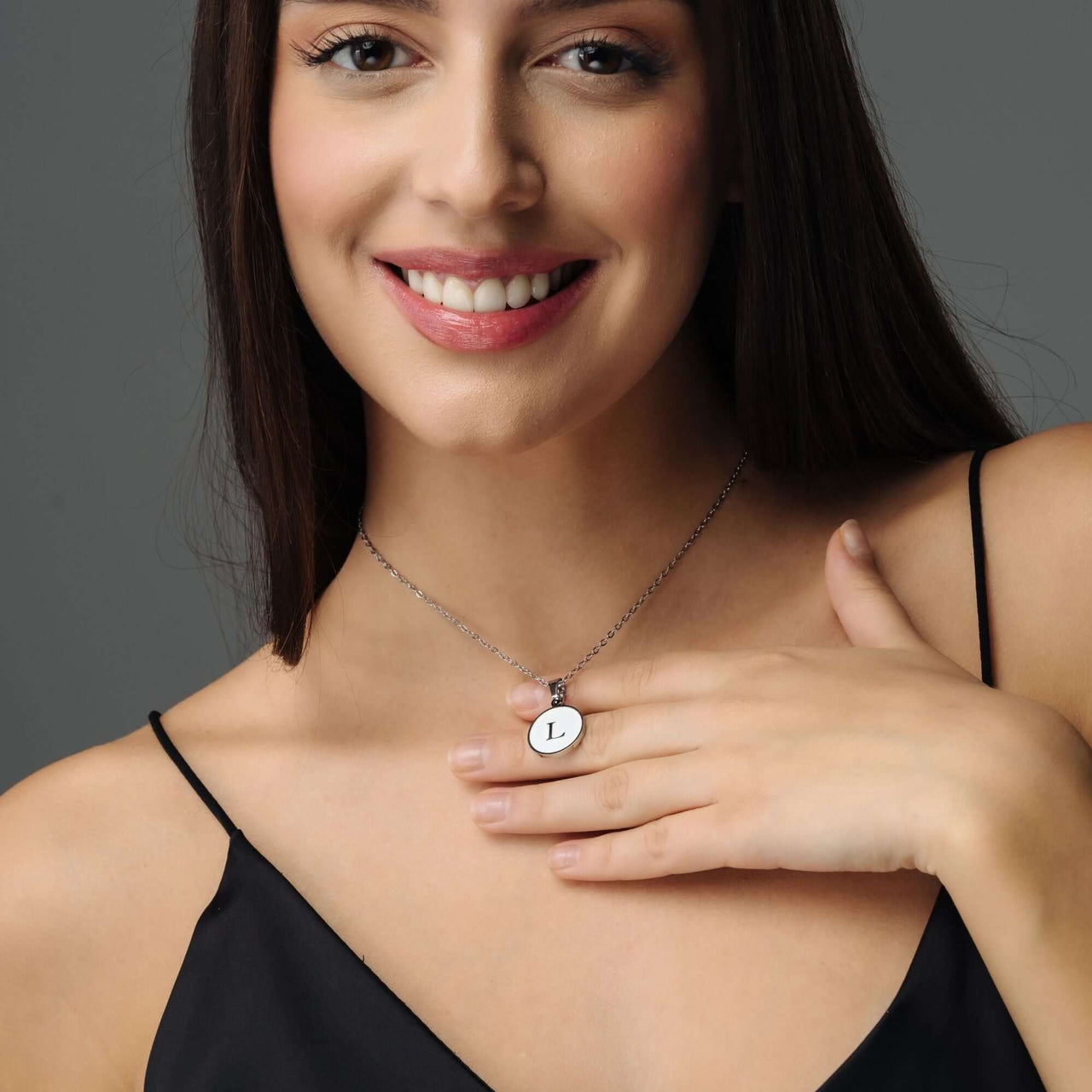 Woman wearing a Dreamy Initial Necklace with letter L, showcasing personalized elegance and style by Brother & Sisters.