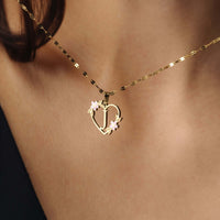Thumbnail for Feminine Initial Necklace featuring a heart design and flowers, crafted by Brother & Sisters in gold for timeless elegance.