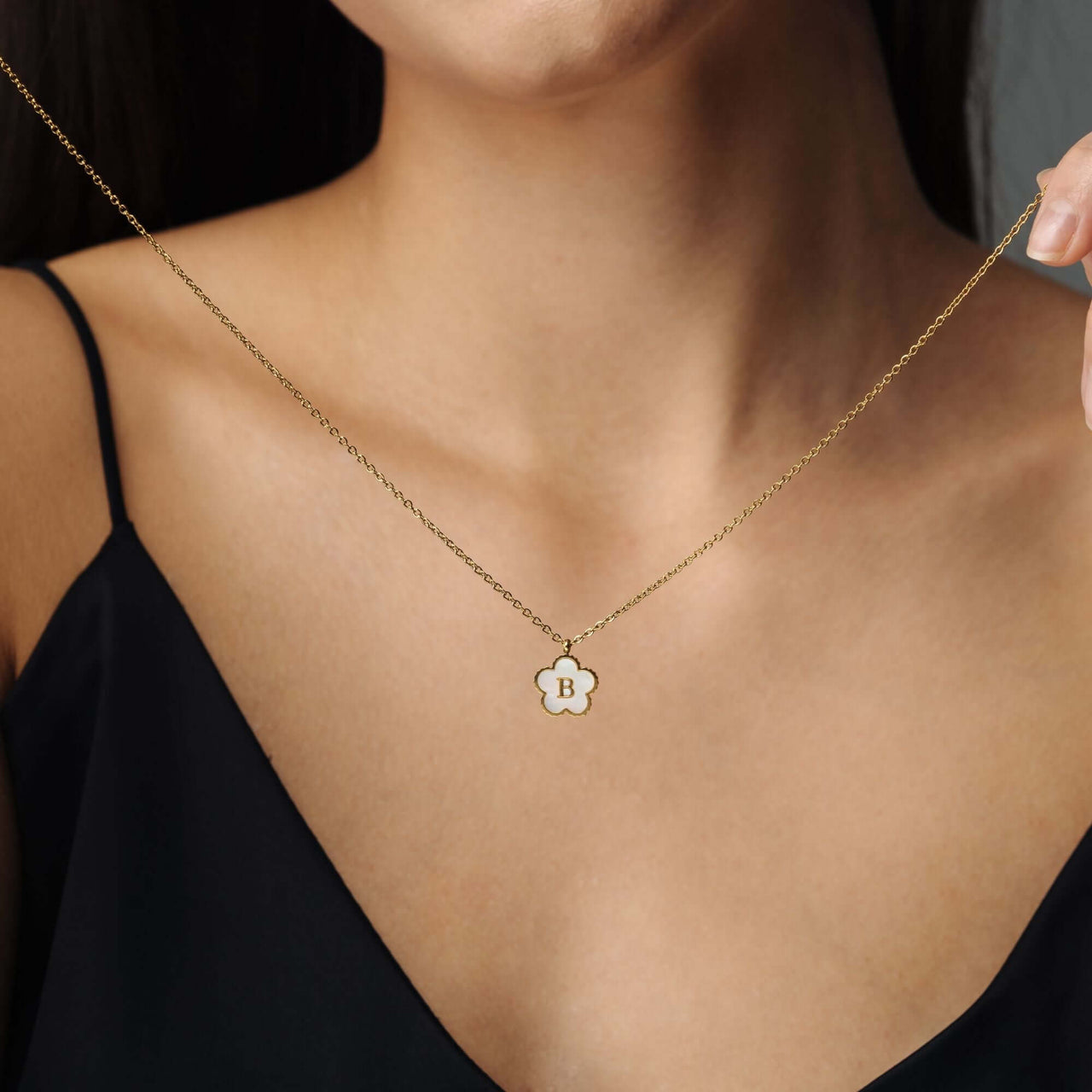 Flower Initial Necklace showcasing floral design and gold elegance worn by a woman, from Brother & Sisters.