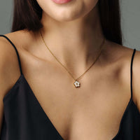 Thumbnail for Flower Initial Necklace featuring a floral design and gold chain by Brother & Sisters, worn elegantly.
