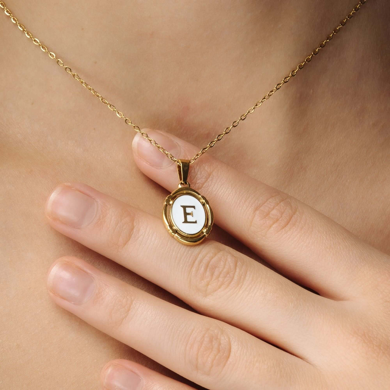 Princess Initial Necklace by Brother & Sisters featuring a gold pendant with the letter E.