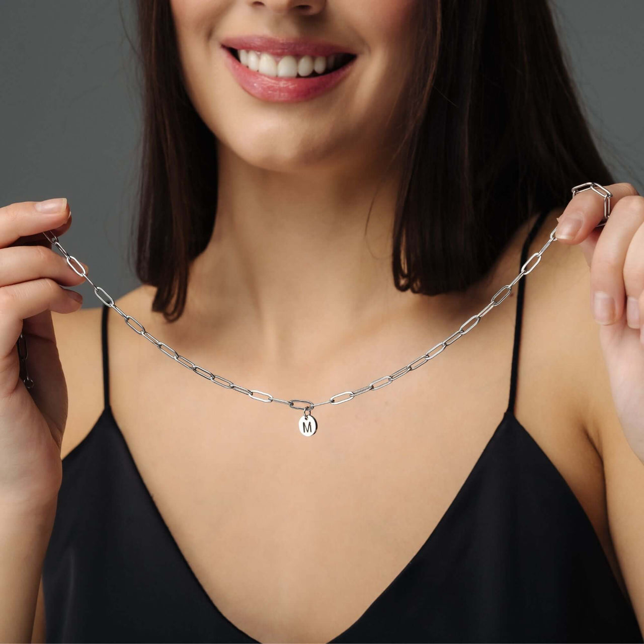 Trendy Initial Necklace worn by a woman, featuring personalized gold elegance by Brother & Sisters.