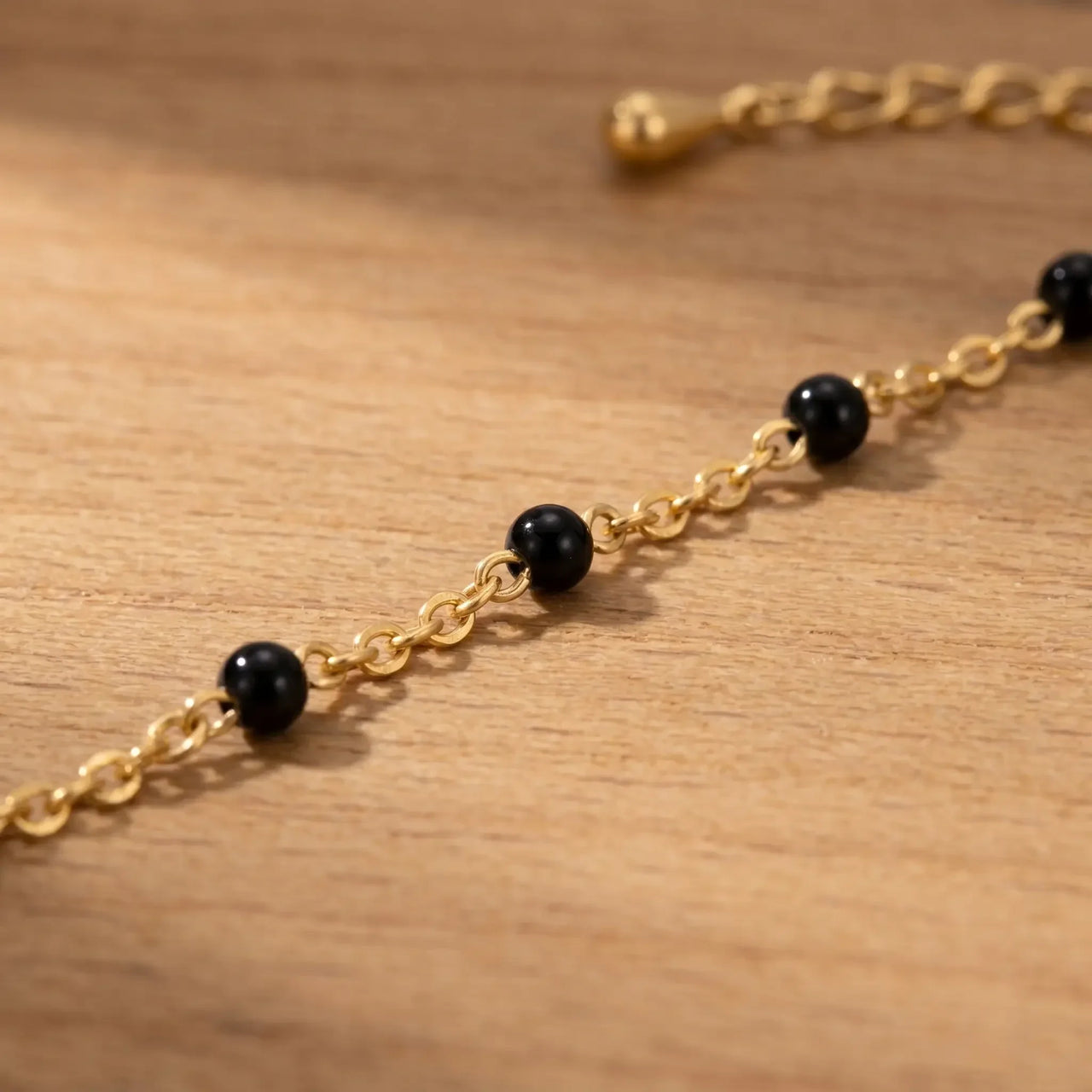 Gold & Onyx Bead Anklet features glossy black enamel beads on an 18K gold-plated chain by Brother & Sisters.