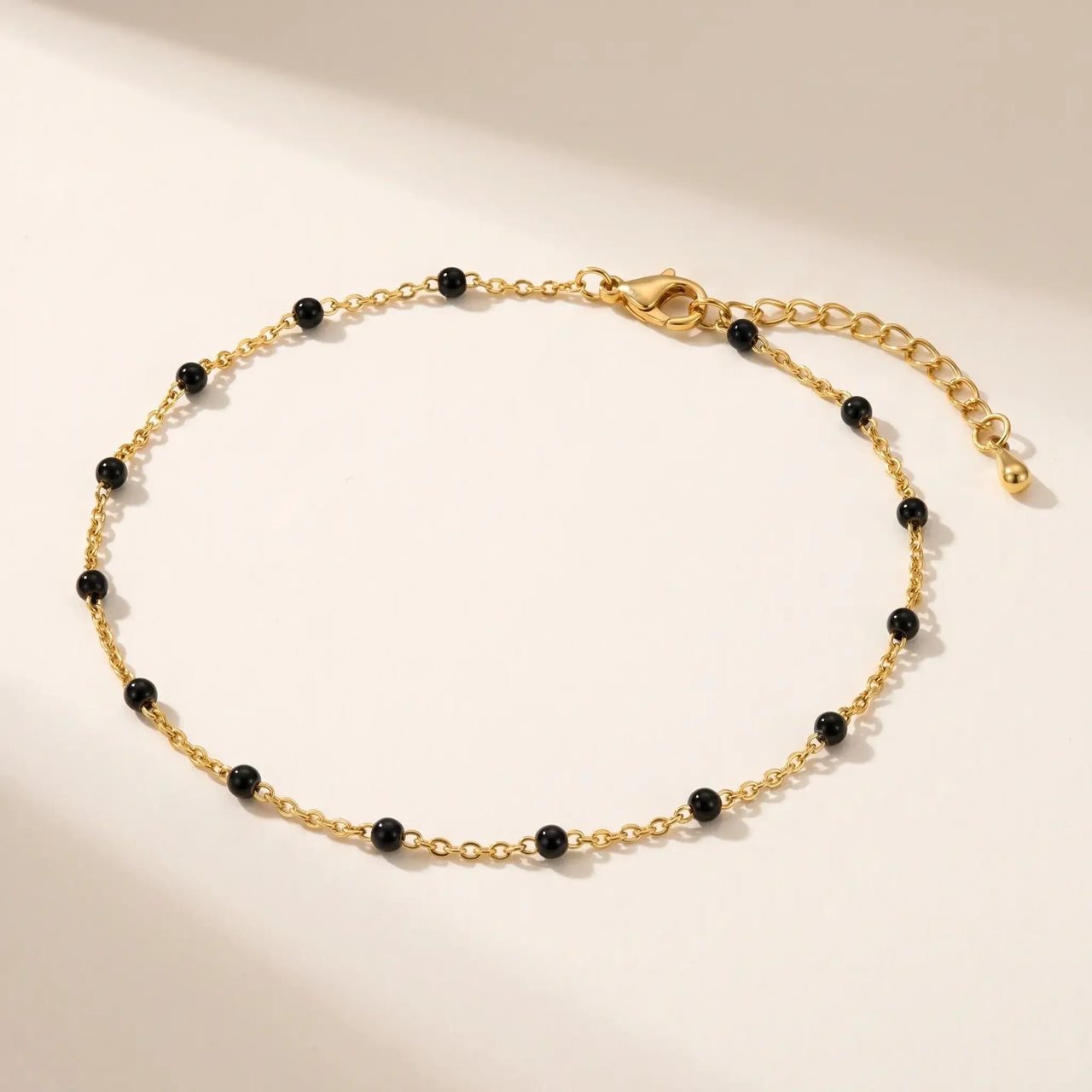 Gold & Onyx Bead Anklet featuring glossy black enamel beads and delicate 18K gold-plated chain by Brother & Sisters.