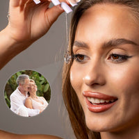 Thumbnail for Woman showcasing Hearts Photo Necklace by Brother & Sisters, holding heart-shaped locket with photo projection.