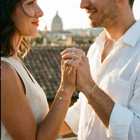 Thumbnail for Italian couple wearing matching gold Heart Bond bracelets, Rome golden hour