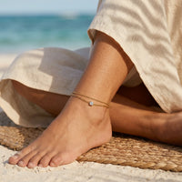 Thumbnail for Amalfi Layered Anklet on Mexican Latina ankle cross-legged on raffia rug in Tulum jungle beach — bohemian summer aesthetic with palm shadows