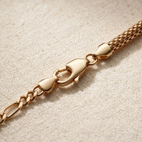 Thumbnail for Maëlle gold anklet macro detail — swivel lobster clasp + figaro extension chain + tube-mesh popcorn weave on cream linen, premium 18K gold PVD hardware
