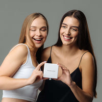 Thumbnail for Two women joyfully unboxing a Kitty Name Necklace gift from Brother & Sisters, showcasing the personalized accessory.
