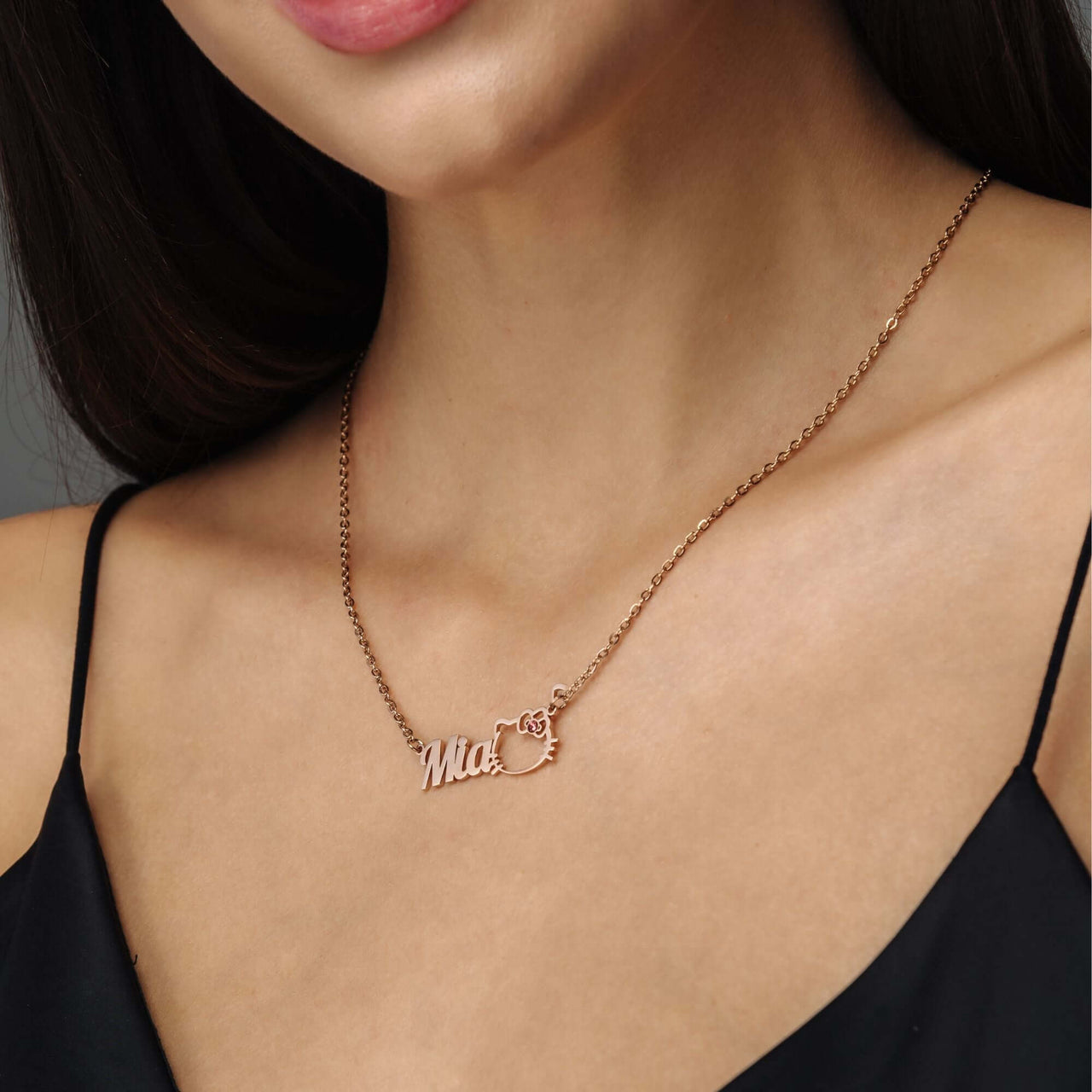 Kitty Name Necklace worn by a model featuring personalized name 'Mia' with a chic design by Brother & Sisters.