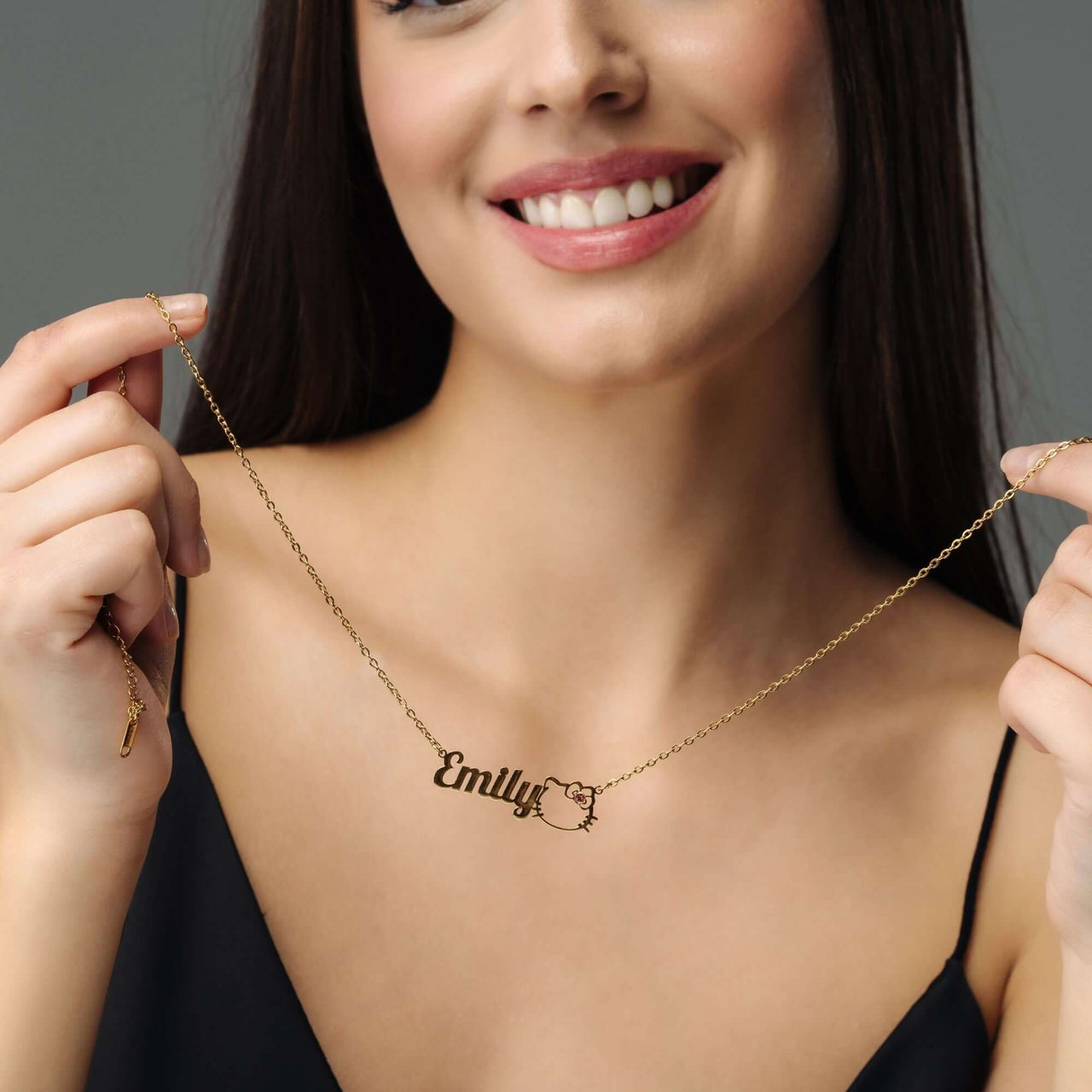 Kitty Name Necklace worn by a smiling woman, featuring a customizable name 'Emily', designed by Brother & Sisters.