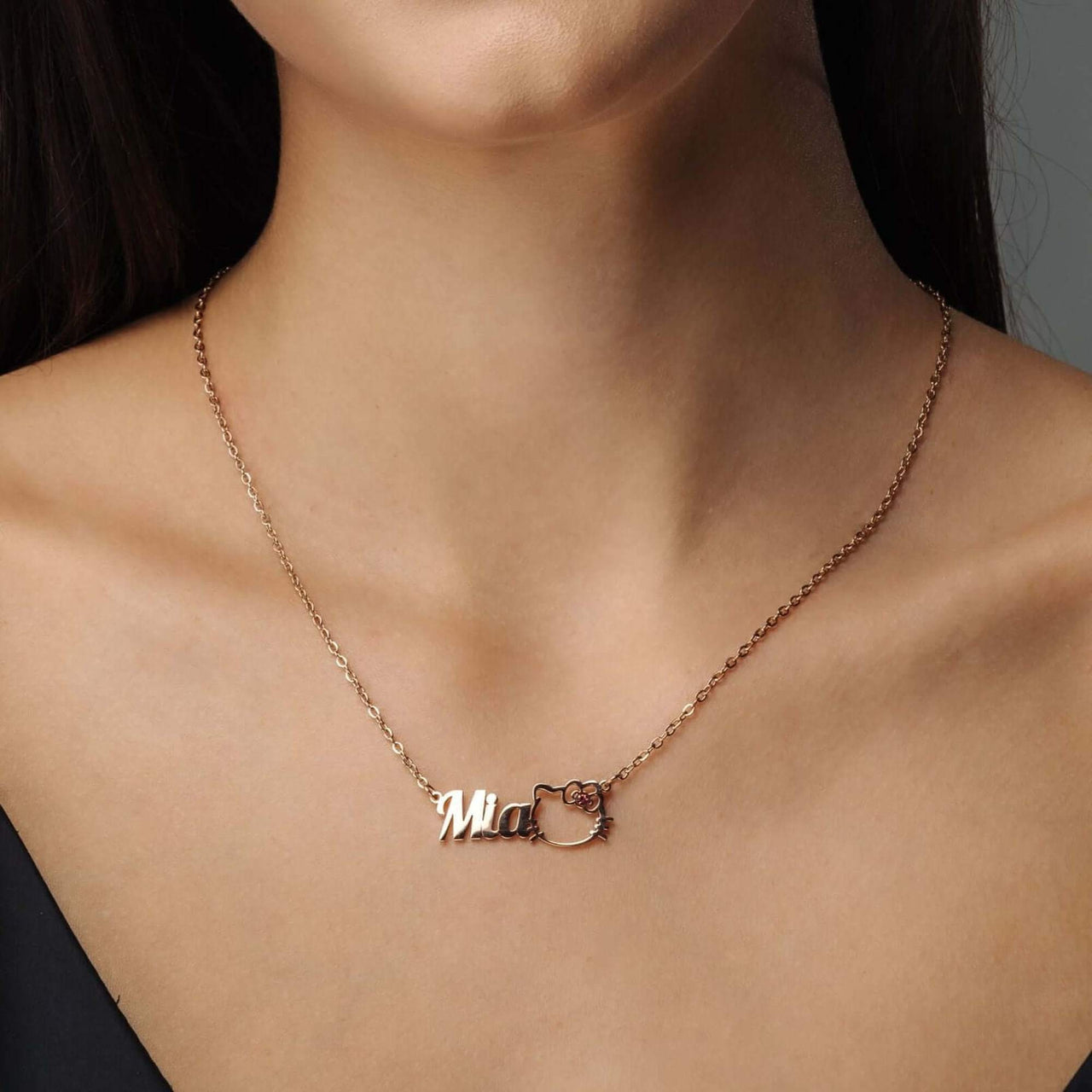 Kitty Name Necklace by Brother & Sisters features a gold name pendant with a cat design, perfect personalized gift.