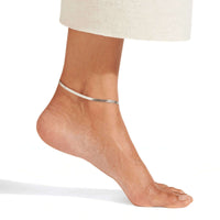 Thumbnail for Layla silver herringbone snake chain anklet worn on tanned ankle — 925 silver-tone flat snake chain for everyday beach wear