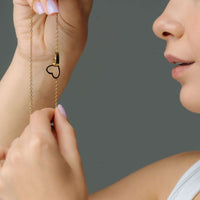 Thumbnail for Person holding the Lovers Name Necklace featuring a heart pendant, designed by Brother & Sisters.