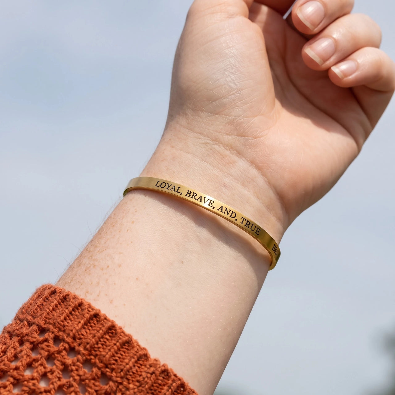 Close-up of the Loyal, Brave, And, True bracelet in gold worn | SKU: lbat-g