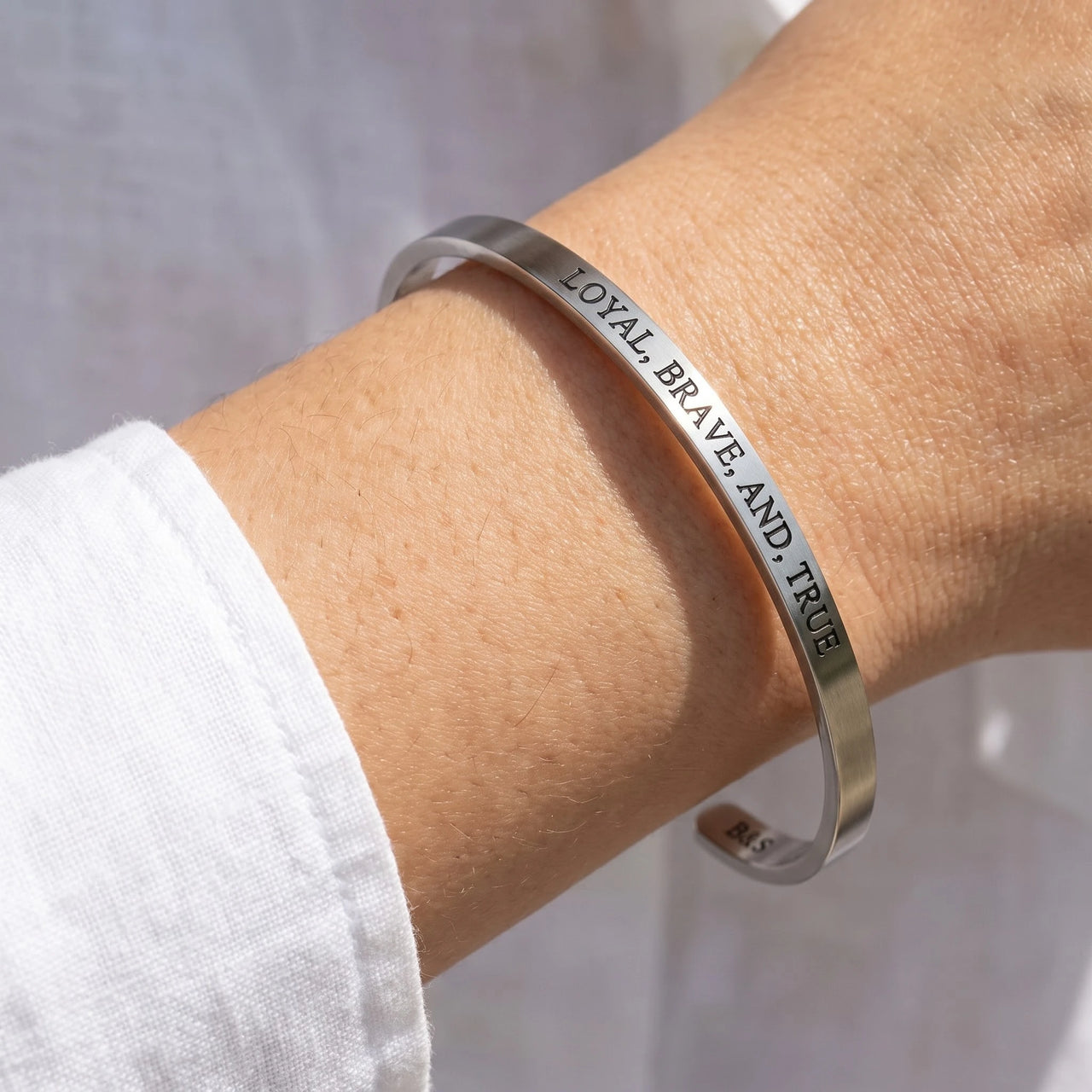 Close-up of the Loyal, Brave, And, True bracelet in silver worn | SKU: lbat-wg