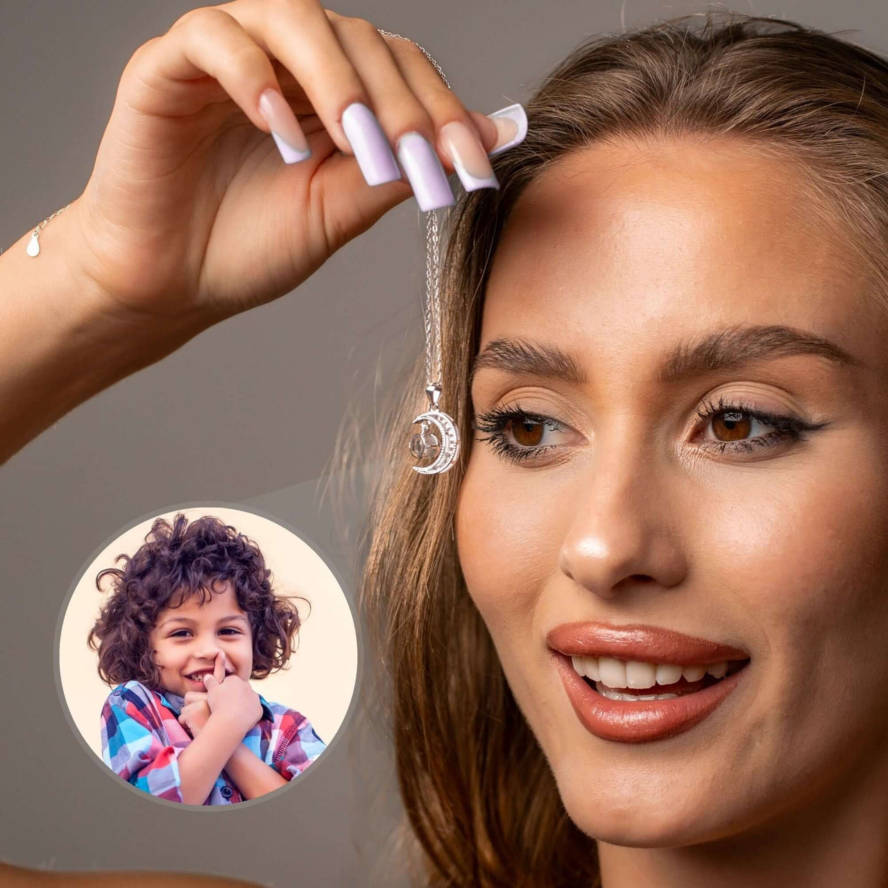 Lucky Moon Photo Necklace held by a woman with a visible photo of a child, showcasing Brother & Sisters elegant jewelry.