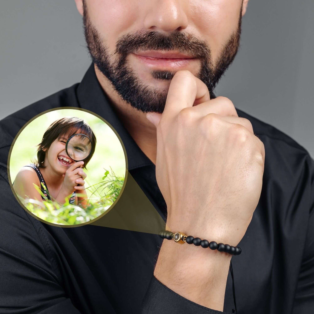 Minimalist Photo Bracelet worn by a man, showcasing a personalized image of a child in a magnifier, by Brother & Sisters.