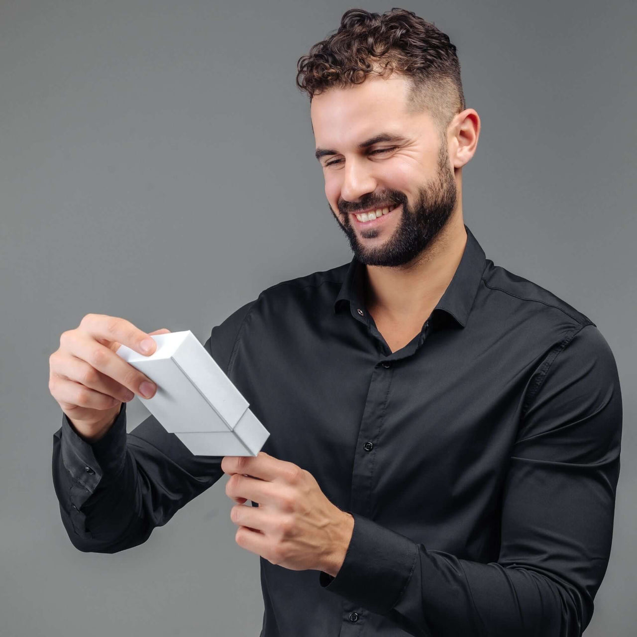 Man Grey Photo Bracelet gift unboxing by a man in a black shirt from Brother & Sisters